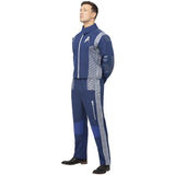 Person wearing a blue and gray tracksuit with white stripes on a white background