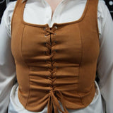 Brown corset vest over a white shirt