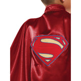 Child dressed as Superman wearing an official DC Comics deluxe cape