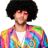 Close-up of colourful tie dye suit with psychedelic rainbow pattern, afro wig and peace pendant