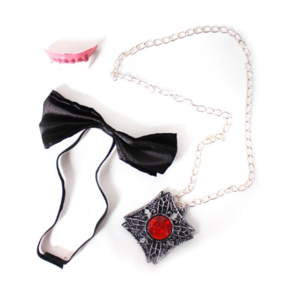 Second image of the Vampire Instant Kit displaying all included items: black bow tie, vampire fangs, and medallion on silver chain, laid out for a clear view of contents.