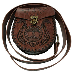 Brown leather bag with embossed designs and a strap on a white background