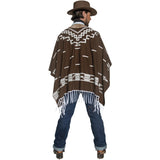 Man wearing a brown poncho with white patterns and fringes, standing against a white background.