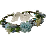 Floral headband with blue flowers and green leaves on a white background