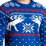 Blue Christmas jumper close-up featuring white reindeer and snowflake knit pattern