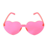 Heart-shaped pink Perspex party glasses.  Description: These vibrant party glasses are crafted from pink Perspex material, forming a whimsical heart shape. The transparent pink color adds a playful touch, making them the perfect accessory for festive occasions