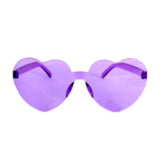 Heart-shaped purple Perspex party glasses.  Description: These vibrant party glasses are crafted from purple Perspex material, forming a whimsical heart shape. The transparent purple colour adds a playful touch, making them the perfect accessory for festive occasions