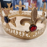 Gold kings crown with coloured gems.